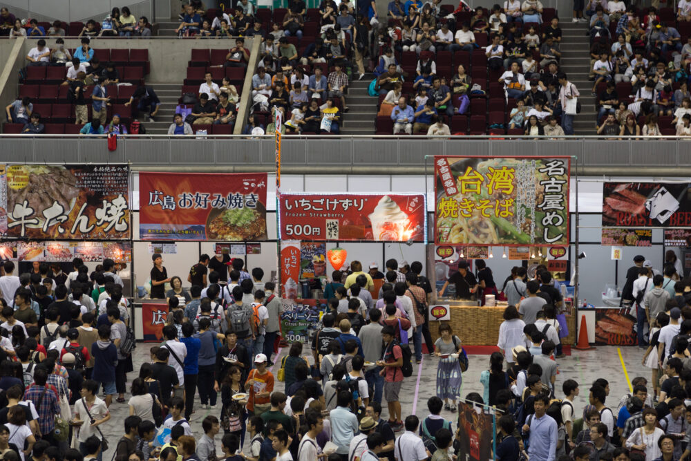 Kuvassa messutapahtuma Japanissa, kuvassa on paljon ihmisiä ja bannereita, joissa japaninkielistä tekstiä